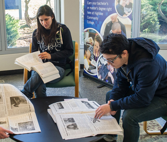 students reading newspapers